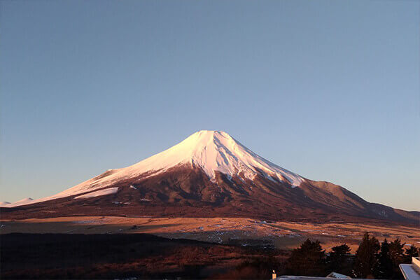 Be greeted by a view of red Fuji from the guest room